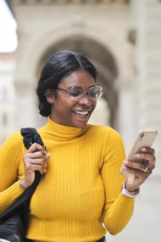 a girl is happy to get instant approval for an online $200 loan