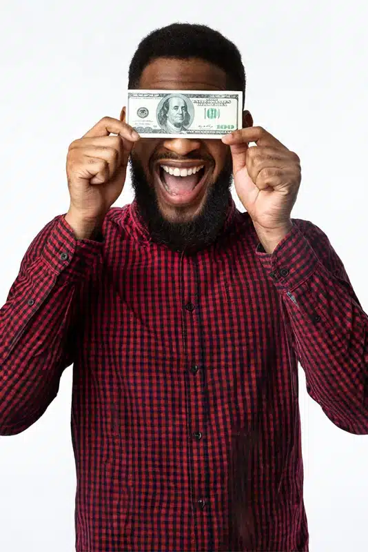 Happy man covering his eyes with a $100 bill