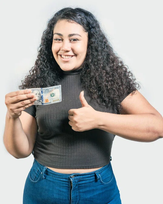 Woman holding a $100 bill and giving a thumbs up after getting a $100 loan