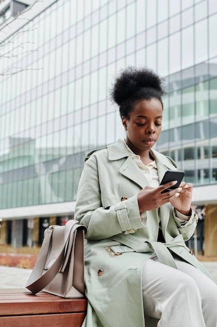 Woman using her smartphone to review an online payday loan application