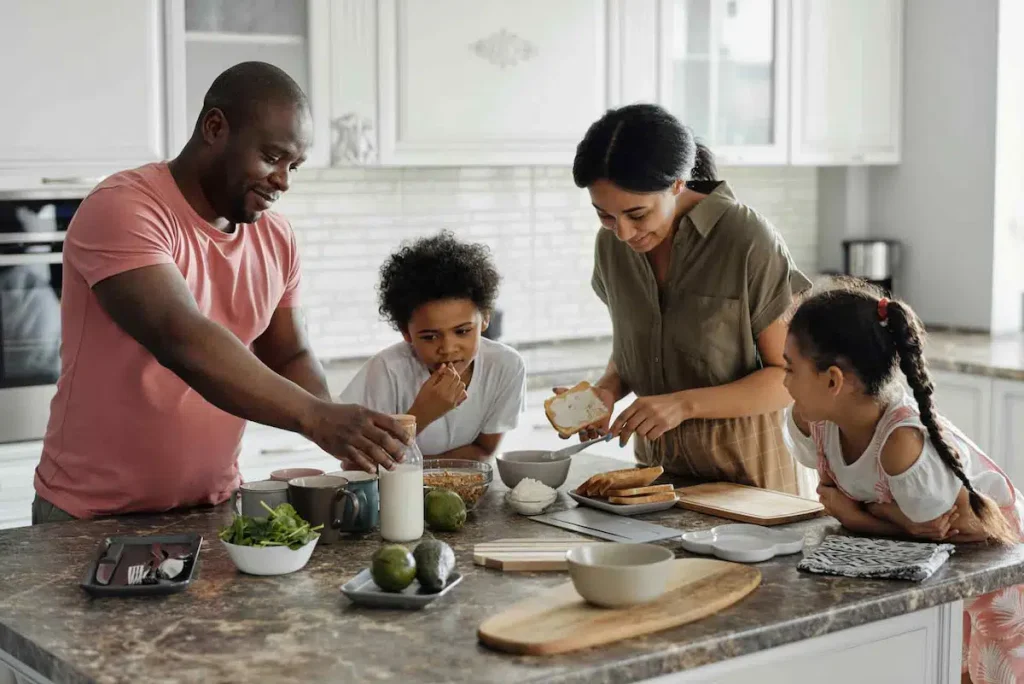 Family cooking breakfast together in their kitchen at home