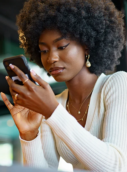 Young woman using her phone to review loan options in South Carolina