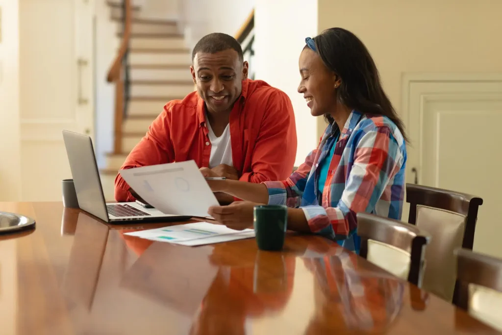 Couple applying for a payday loan online at home