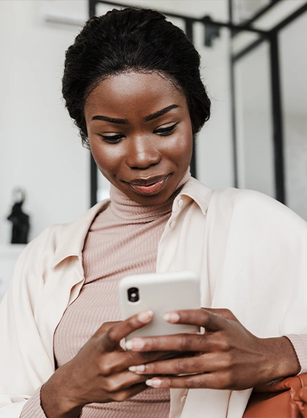 Smiling woman using her phone to review loan options in Ohio