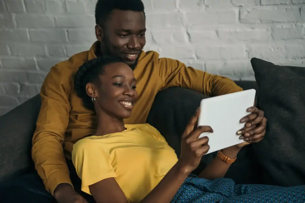 Happy couple using a tablet to check payday loan details in Texas