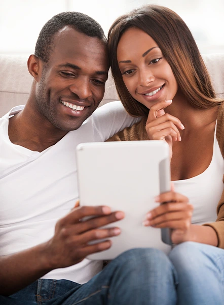 Couple looking at a laptop while deciding whether to apply for a payday loan online