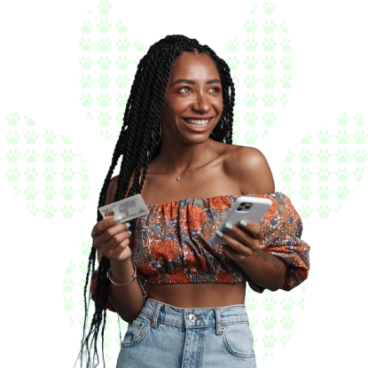 Smiling young woman with long braids holding a credit card and a phone, on a white background with a paw print pattern.