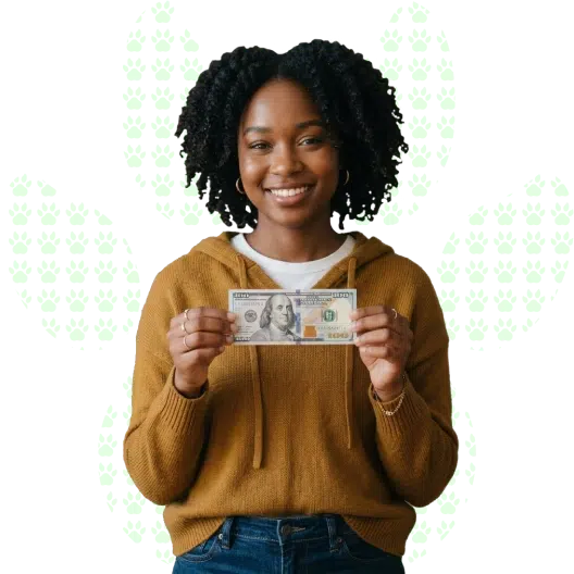 Close-up of a young woman smiling as she holds a 100 dollar bill in her hands