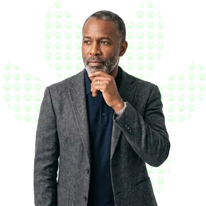 A confident serious man standing with his hand on his chin, thinking over guaranteed loan requirements