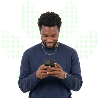 A young man looking at his smartphone, searching online for a fast, income-based loan